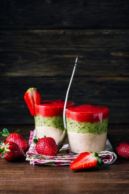 three-layer-smoothie-from-banana-kiwi-and-strawberry-on-a-wooden-background.jpg