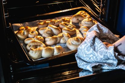 woman-taking-out-homemade-baked-dessert-from-oven.jpg